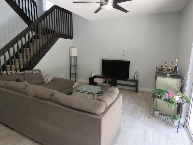 16815 SW 49th Ct, Miramar, FL 33027 - living room featuring light wood-type flooring, a ceiling fan, baseboards, and stairs