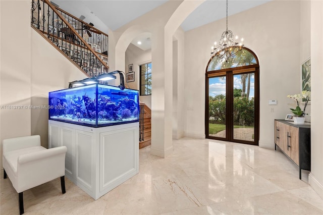 1437 SE 13th St, Deerfield Beach, FL 33441 - entrance foyer featuring a towering ceiling, healthy amount of natural light, arched walkways, french doors, and marble tiled floors