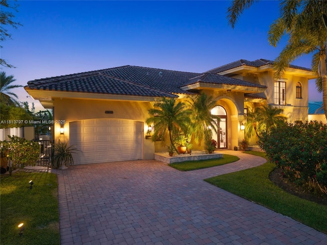 1437 SE 13th St, Deerfield Beach, FL 33441 - mediterranean / spanish home featuring stucco siding, decorative driveway, a tile roof, and a garage