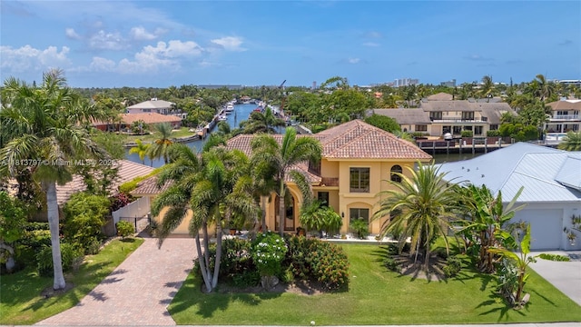 1437 SE 13th St, Deerfield Beach, FL 33441 - view of front of house with a tile roof, decorative driveway, a water view, stucco siding, and a residential view