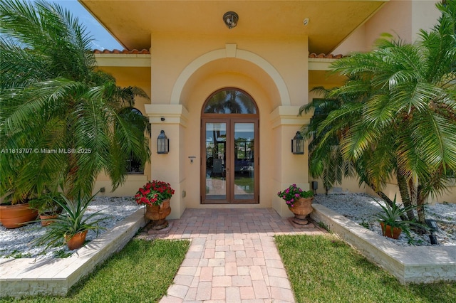 1437 SE 13th St, Deerfield Beach, FL 33441 - entrance to property with french doors, stucco siding, and a tiled roof