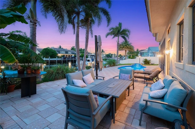 1437 SE 13th St, Deerfield Beach, FL 33441 - patio terrace at dusk featuring outdoor lounge area, a patio area, and a fenced backyard