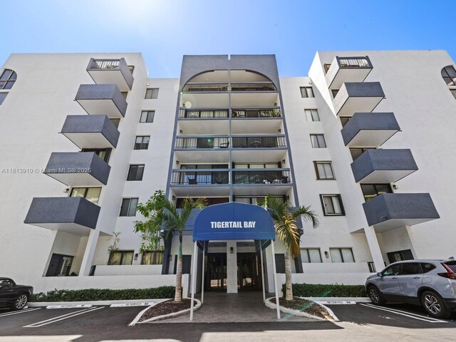 2715 Tigertail Ave Unit 102, Miami, FL 33133 - view of apartment building / complex featuring uncovered parking