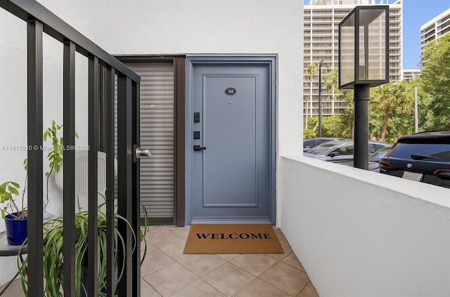 2715 Tigertail Ave Unit 102, Miami, FL 33133 - view of exterior entry with stucco siding and a balcony