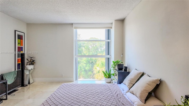20355 NE 34th Ct Unit 325, Aventura, FL 33180 - bedroom with a textured ceiling and baseboards