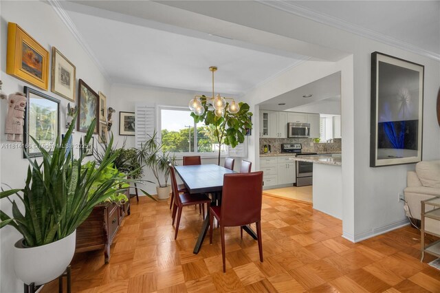 2825 Granada Blvd Unit 3B, Coral Gables, FL 33134 - dining space featuring crown molding and a chandelier
