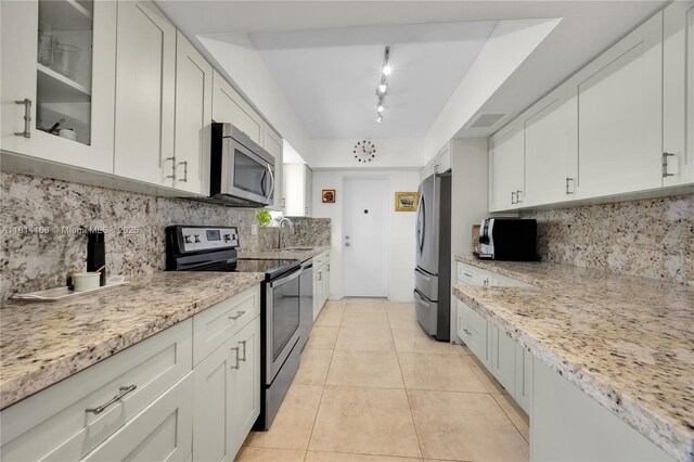 2825 Granada Blvd Unit 3B, Coral Gables, FL 33134 - kitchen with stainless steel appliances, track lighting, and decorative backsplash