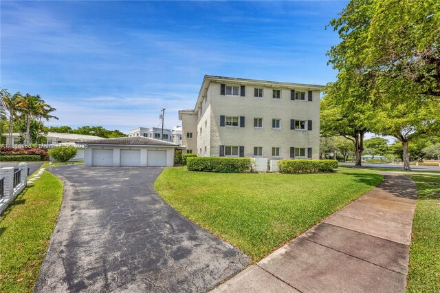 2825 Granada Blvd Unit 3B, Coral Gables, FL 33134 - view of front facade featuring a front yard and a detached garage