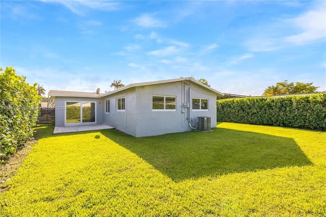 2111 NE 14th Ct, Hollywood, FL 33020 - back of property featuring central AC unit, stucco siding, and a patio area