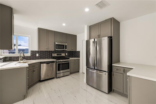 2111 NE 14th Ct, Hollywood, FL 33020 - kitchen featuring stainless steel appliances, light marble finish flooring, a sink, gray cabinetry, and recessed lighting