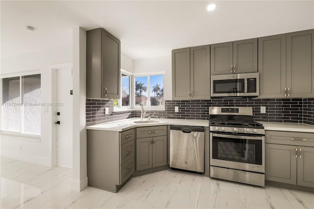 2111 NE 14th Ct, Hollywood, FL 33020 - kitchen with stainless steel appliances, light marble finish flooring, a sink, gray cabinets, and light countertops
