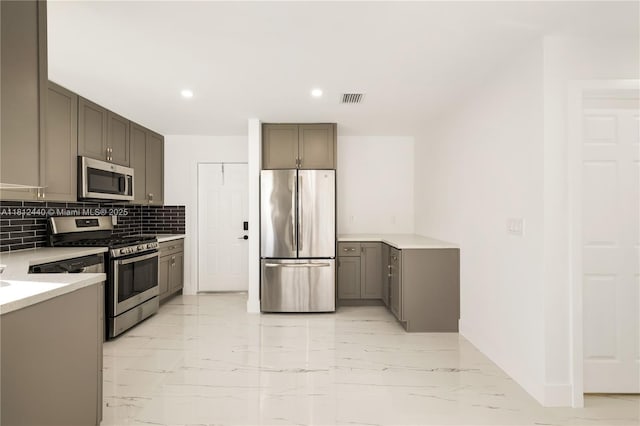 2111 NE 14th Ct, Hollywood, FL 33020 - kitchen with stainless steel appliances, light marble finish flooring, tasteful backsplash, light countertops, and recessed lighting