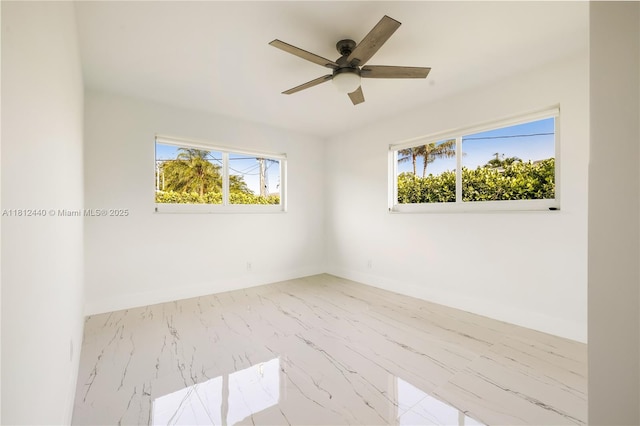 2111 NE 14th Ct, Hollywood, FL 33020 - empty room featuring ceiling fan, marble finish floors, and baseboards