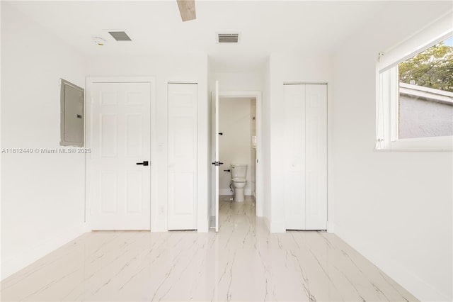 2111 NE 14th Ct, Hollywood, FL 33020 - unfurnished bedroom featuring electric panel, marble finish floors, baseboards, and ensuite bath
