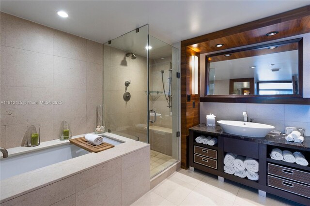 6801 Collins Ave Unit 510Door 512, Miami Beach, FL 33141 - bathroom with tile walls, tile patterned flooring, vanity, a shower stall, and a bath