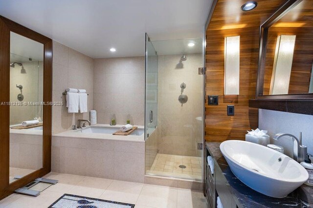6801 Collins Ave Unit 510Door 512, Miami Beach, FL 33141 - bathroom featuring a garden tub, a stall shower, tile patterned floors, vanity, and tile walls