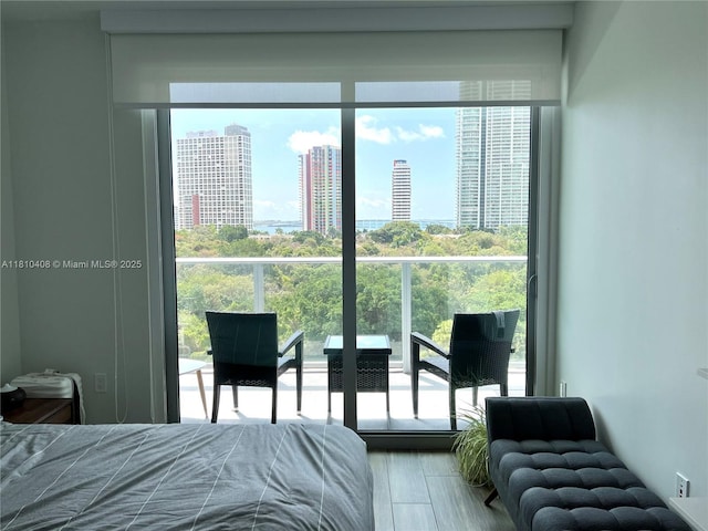 1600 SW 1st Ave Unit 813, Miami, FL 33129 - bedroom with multiple windows, a city view, and wood finished floors