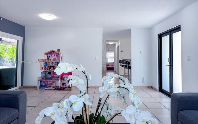 14751 SW 158th St, Miami, FL 33187 - living room with light tile patterned floors and baseboards