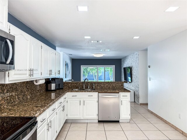 14751 SW 158th St, Miami, FL 33187 - kitchen featuring appliances with stainless steel finishes, a sink, white cabinetry, a peninsula, and dark stone countertops