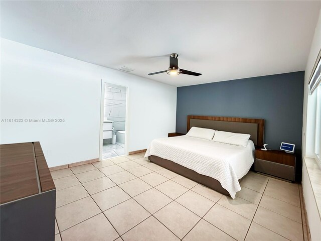 14751 SW 158th St, Miami, FL 33187 - bedroom with light tile patterned floors, ceiling fan, baseboards, and ensuite bath