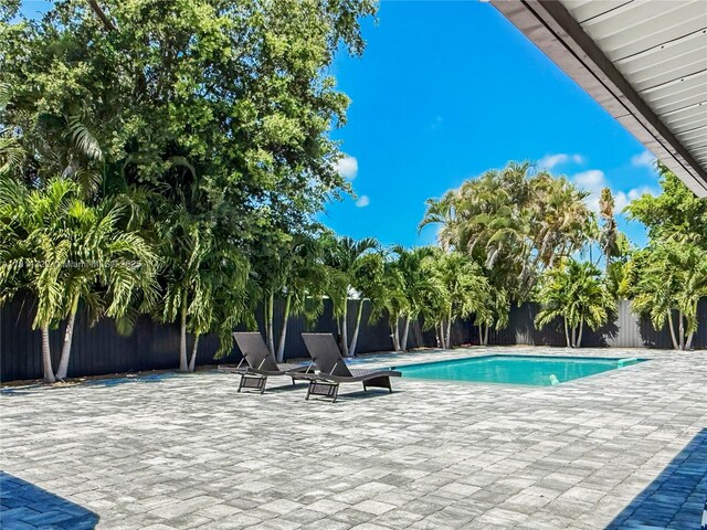 14751 SW 158th St, Miami, FL 33187 - view of pool featuring a patio and a fenced backyard
