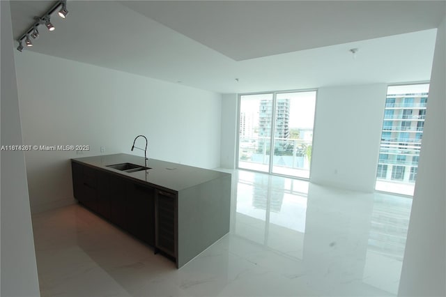 1080 Brickell Ave Unit 1409, Miami, FL 33131 - kitchen featuring a sink, a wall of windows, a peninsula, modern cabinets, and track lighting