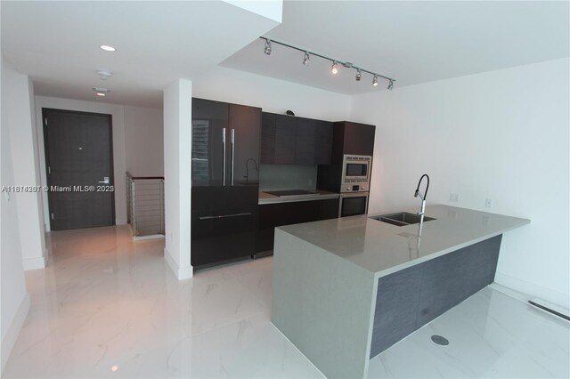 1080 Brickell Ave Unit 1409, Miami, FL 33131 - kitchen featuring modern cabinets, a sink, appliances with stainless steel finishes, baseboards, and light countertops