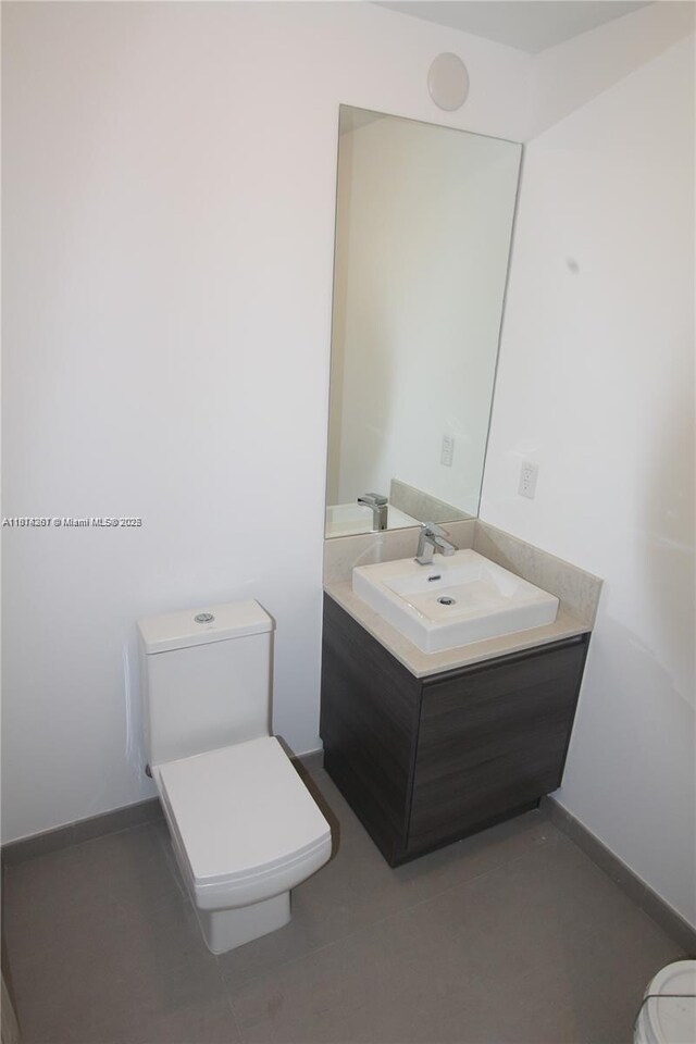 1080 Brickell Ave Unit 1409, Miami, FL 33131 - bathroom featuring toilet, vanity, and baseboards
