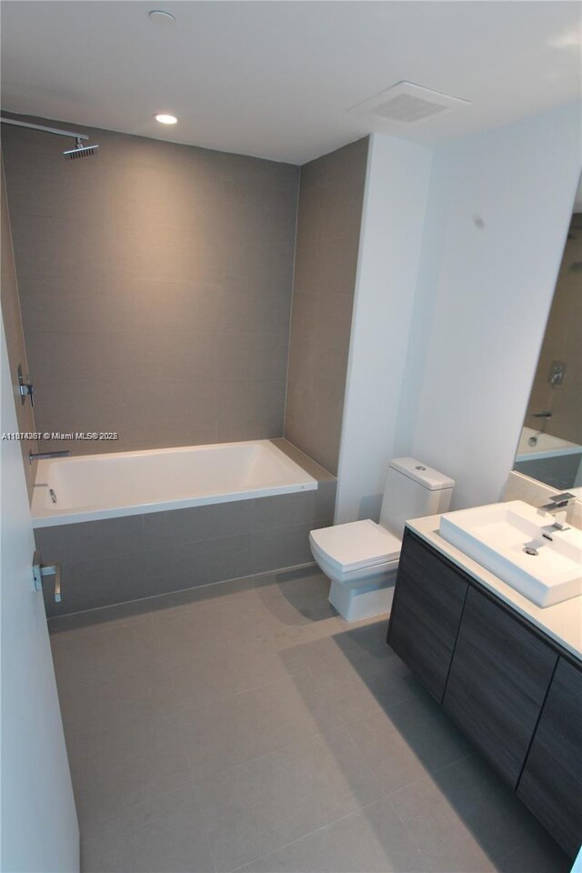 1080 Brickell Ave Unit 1409, Miami, FL 33131 - full bath featuring a tub, vanity, toilet, tile patterned floors, and recessed lighting