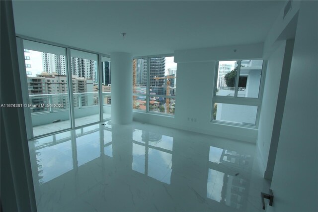 1080 Brickell Ave Unit 1409, Miami, FL 33131 - unfurnished room featuring a view of city and marble look tile flooring