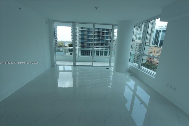 1080 Brickell Ave Unit 1409, Miami, FL 33131 - spare room featuring plenty of natural light, marble finish flooring, and a pendent fire sprinkler