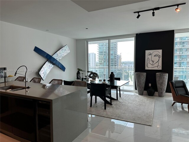 1080 Brickell Ave Unit 1409, Miami, FL 33131 - dining area with rail lighting, light marble finish flooring, and a city view