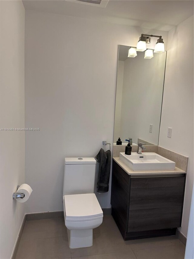 1080 Brickell Ave Unit 1409, Miami, FL 33131 - bathroom featuring vanity, toilet, tile patterned flooring, and baseboards