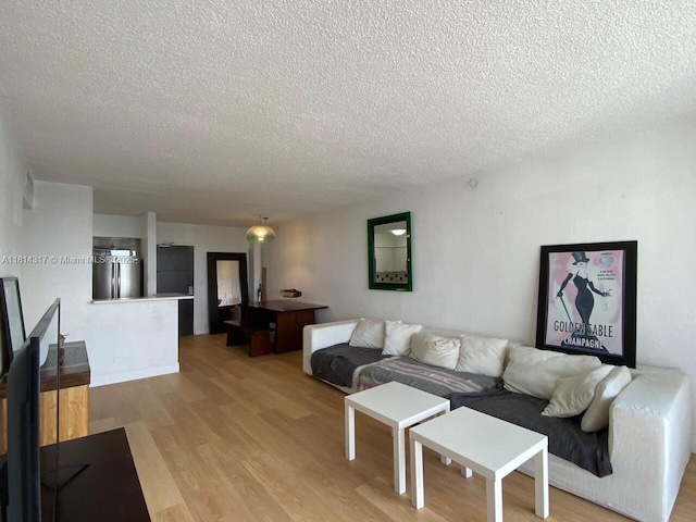 1500 Bay Rd Unit 1274S, Miami Beach, FL 33139 - living area featuring a textured ceiling and light wood-style floors