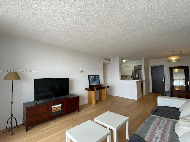1500 Bay Rd Unit 1274S, Miami Beach, FL 33139 - living room with a textured ceiling, light wood-type flooring, and baseboards