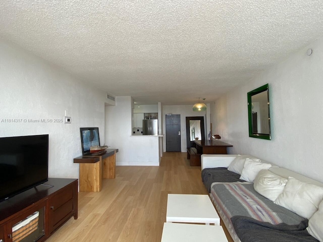 1500 Bay Rd Unit 1274S, Miami Beach, FL 33139 - living room featuring light wood-style floors and a textured ceiling