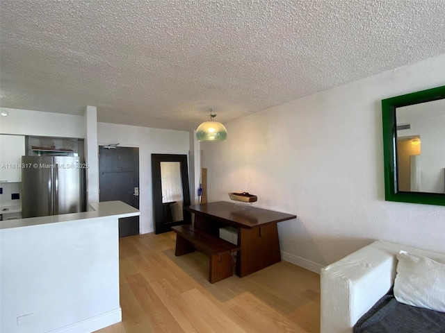 1500 Bay Rd Unit 1274S, Miami Beach, FL 33139 - dining space featuring light wood-style floors and a textured ceiling