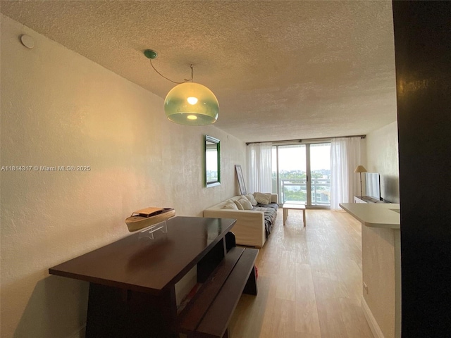 1500 Bay Rd Unit 1274S, Miami Beach, FL 33139 - dining space featuring a textured ceiling, light wood-type flooring, and a textured wall
