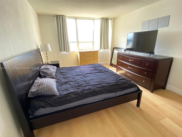 1500 Bay Rd Unit 1274S, Miami Beach, FL 33139 - bedroom featuring wood finished floors, a textured ceiling, and baseboards
