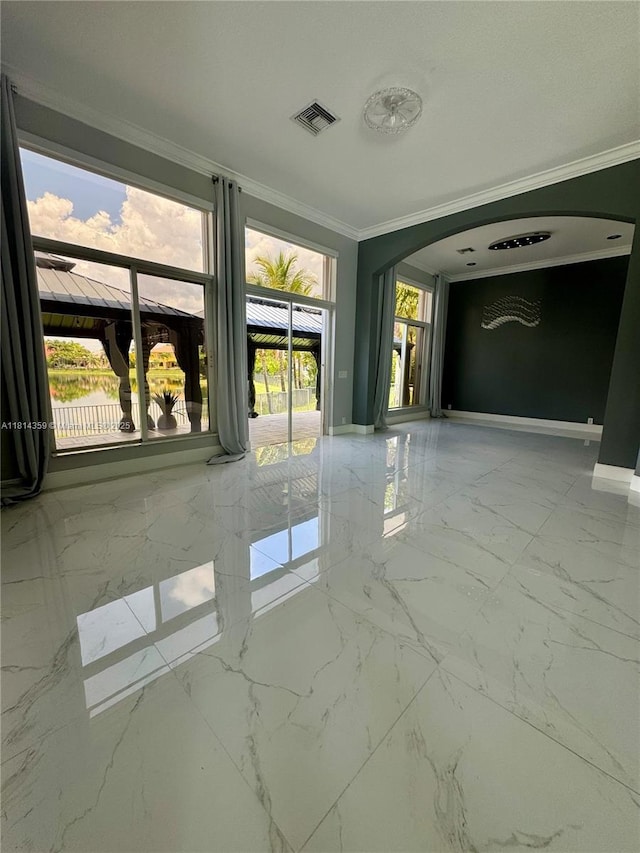 4248 SW 185th Ave, Miramar, FL 33029 - unfurnished room with arched walkways, ornamental molding, light marble finish flooring, and baseboards