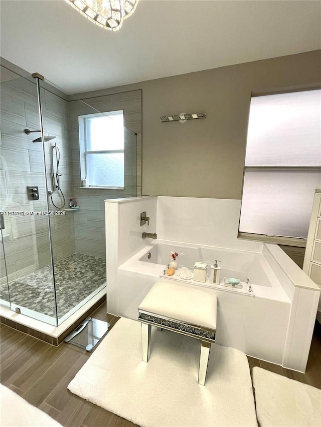 4248 SW 185th Ave, Miramar, FL 33029 - bathroom featuring a bath, a shower stall, and wood finished floors