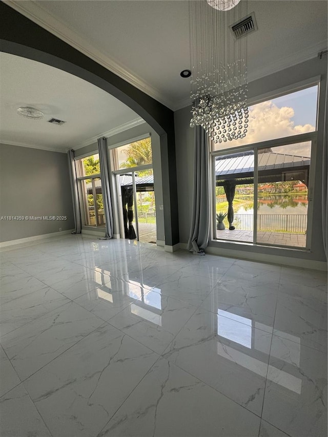 4248 SW 185th Ave, Miramar, FL 33029 - unfurnished room with ornamental molding, marble look tile flooring, arched walkways, baseboards, and a chandelier
