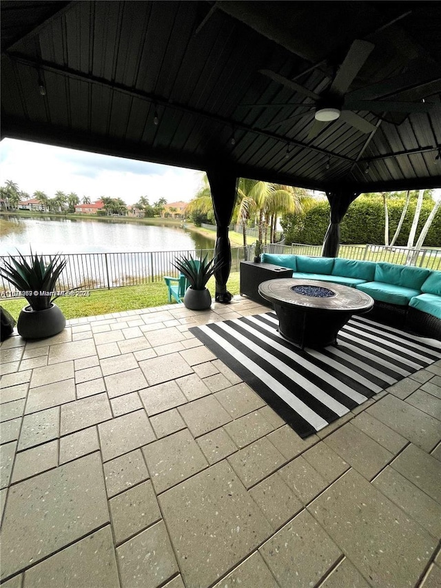 4248 SW 185th Ave, Miramar, FL 33029 - fenced backyard featuring a ceiling fan, an outdoor living space with a fire pit, a water view, and a patio area