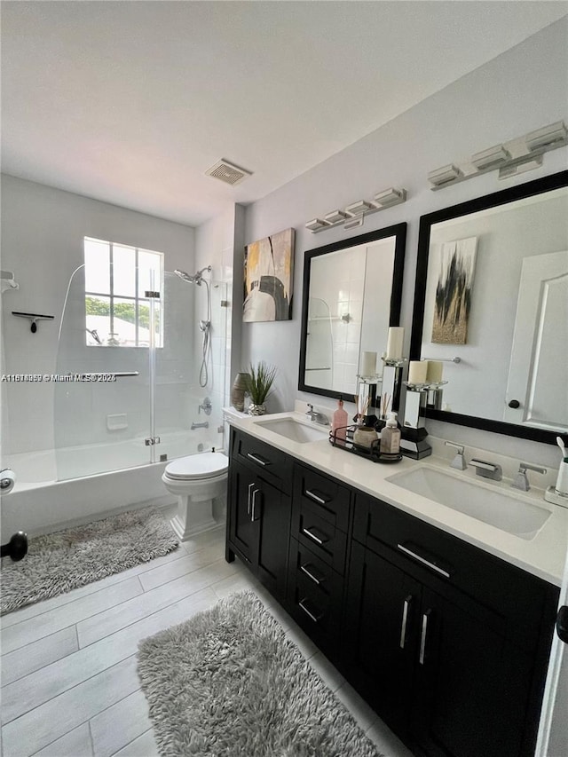 4248 SW 185th Ave, Miramar, FL 33029 - bathroom with combined bath / shower with glass door, double vanity, toilet, and wood tiled floors