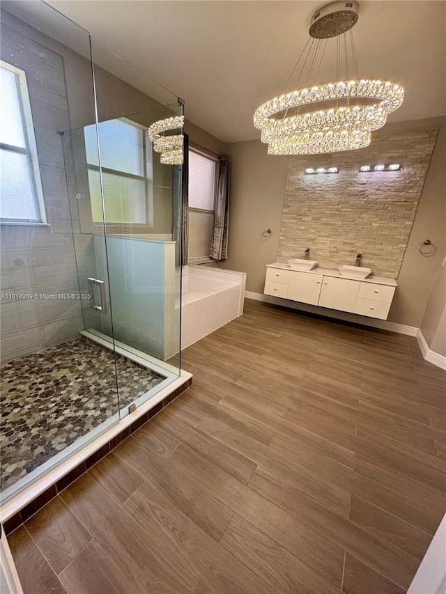 4248 SW 185th Ave, Miramar, FL 33029 - full bath featuring a chandelier, a stall shower, wood finished floors, baseboards, and a garden tub