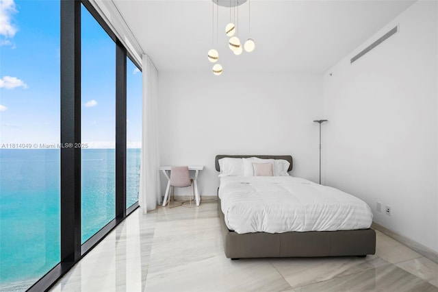 18555 Collins Ave Unit 2105, Sunny Isles Beach, FL 33160 - bedroom featuring a water view and baseboards