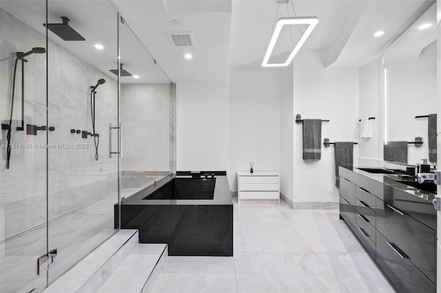 18555 Collins Ave Unit 2105, Sunny Isles Beach, FL 33160 - bathroom featuring a shower stall, vanity, recessed lighting, marble finish floors, and a bathtub