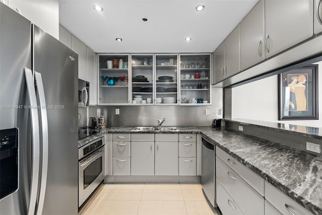 540 W Ave Unit 914, Miami Beach, FL 33139 - kitchen with appliances with stainless steel finishes, open shelves, recessed lighting, gray cabinetry, and dark stone counters
