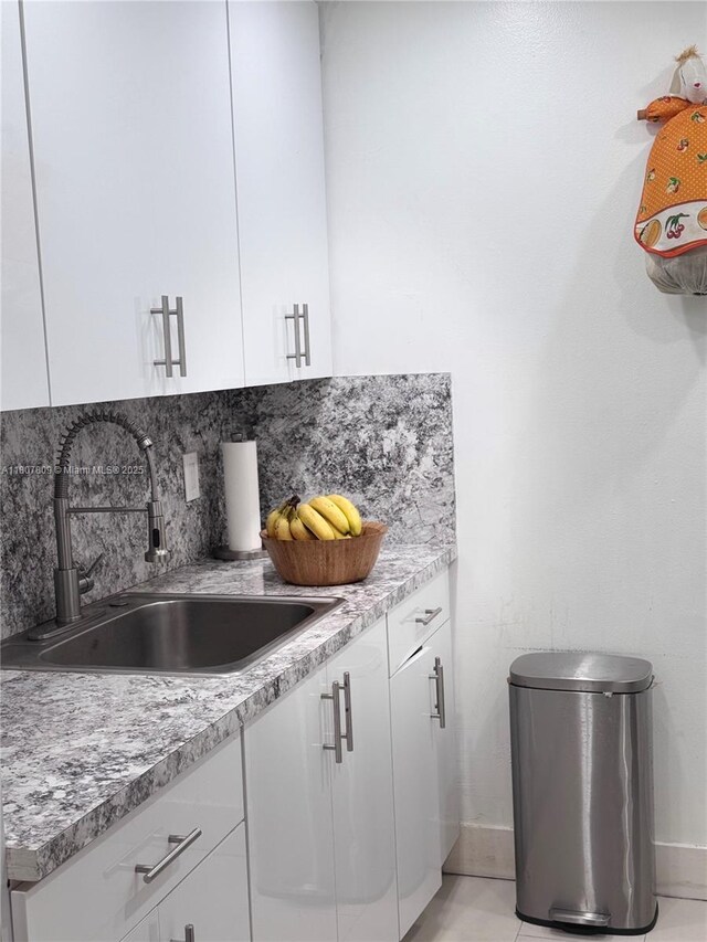 8260 SW 210th St Unit 310, Cutler Bay, FL 33189 - kitchen with a sink, white cabinetry, baseboards, and light countertops