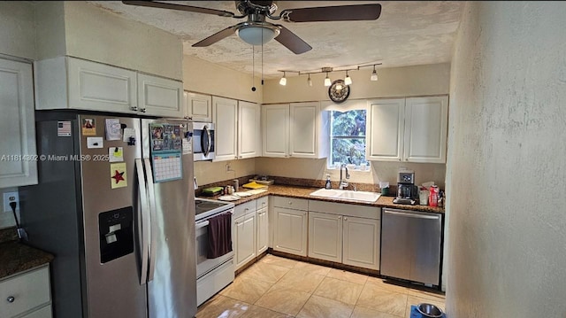 3390 SW 15th Ct, Fort Lauderdale, FL 33312 - kitchen with appliances with stainless steel finishes, white cabinets, a ceiling fan, light tile patterned flooring, and a textured wall